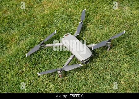 Closeup Looking down birds eye view onto stationary DJI Mavic 2 PRO personal Drone laying on the ground Stock Photo