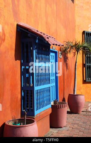 Colourful painted house-front with terracotta pots in the historic centre of Cartagena in Colombia Stock Photo