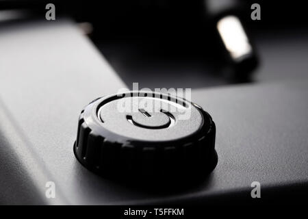 Black plastic power button with power adjustment function. 12 volt plug. The concept of the development of modern technology. Contrast dark look Stock Photo