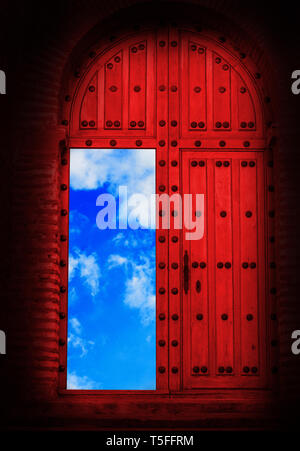 Antique red wooden door and blue sky Stock Photo