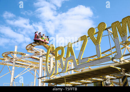 People enjoying the Crazy Mouse rollercoaster fairground ride at Brighton funfair, Brighton Palace Pier, East Sussex, England, UK Stock Photo