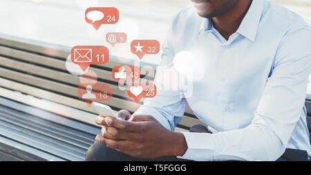 Businessman using social media with notification icons Stock Photo