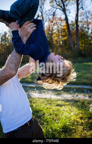 Father playing with his little son  outdoors Stock Photo