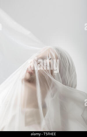 Graceful woman trapped in a veil Stock Photo
