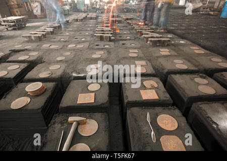 workers in a foundry at the melting furnace Stock Photo