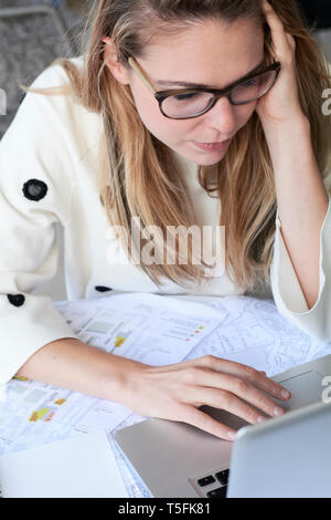 Young blond freelancer working on laptop Stock Photo