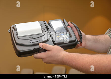 Man Holding Portable Barcode Printer and Reader Computer Device Stock Photo