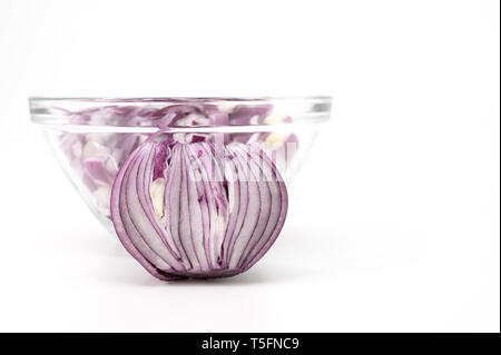 Chopped red onion in a glass bowl on a white background Stock Photo