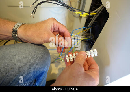 Man doing wiring and connecting wires Stock Photo