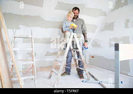 Father and son working on loft conversion Stock Photo