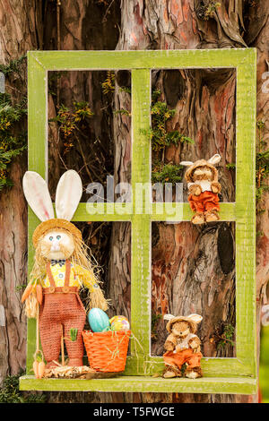 Easter bunnies - puppet family gathering - window frame decoration Stock Photo