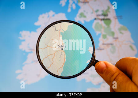 Dublin, Ireland. Political map. City visualization illustrative concept on display screen through magnifying glass in the hand. Stock Photo