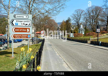 BRAEMAR ABERDEENSHIRE SCOTLAND THE MAIN STREET WITH ROAD SIGNS AND HOUSES AND GARDENS IN SPRING Stock Photo