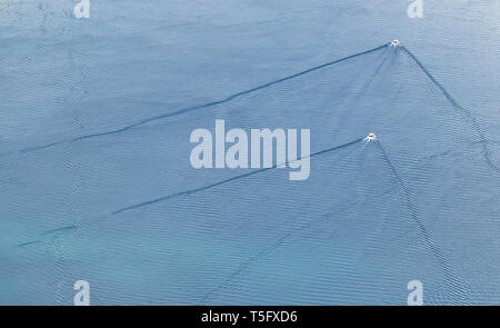 Water texture - wave pattern, gentle wind ripples the surface of the Adriatic Sea. Parallel and diagonal lines.White points - little sailboats. Stock Photo