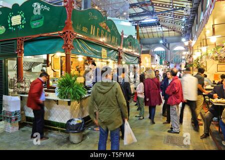 FLORENCE, ITALY - APRIL 30, 2015: People shop at Mercato Centrale market in Florence, Italy. The market is an ultimate Italian shopping experience. It Stock Photo