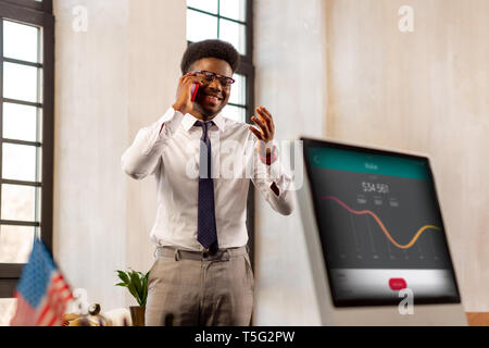 Nice African American man talking with his client on the phone Stock Photo