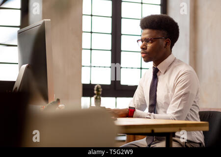 Nice serious man concentrating on his work Stock Photo