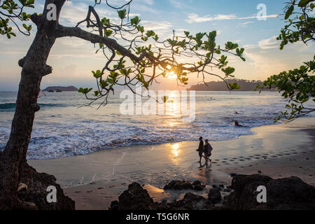 Couple walking in the sunset on Espadilla Norte Beach, Manuel Antonio, Quepos, Costa Rica Stock Photo