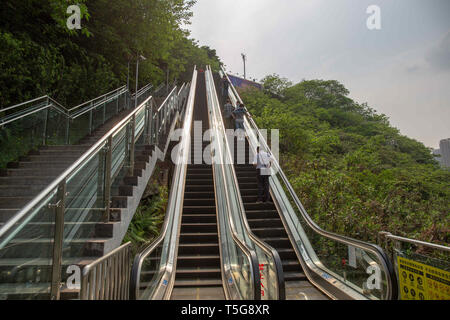 Chongqing, Chongqing, China. 24th Apr, 2019. Chongqing, CHINA-The 60-meter-long and 28-meter-tall escalator can be seen at the mountain in southwest ChinaÃ¢â‚¬â„¢s Chongqing. Credit: SIPA Asia/ZUMA Wire/Alamy Live News Stock Photo