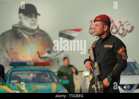 Baghdad, Iraq. 24th Apr, 2019. An armed member of the Iraqi Special Operations Forces secures the premises where a conference is being held by the predominantly Shia Muslim Popular Mobilization Forces (PMF) to honour Iranian fighters who died fighting the so-called Islamic State (IS) terror group. Credit: Ameer Al Mohammedaw/dpa/Alamy Live News Stock Photo
