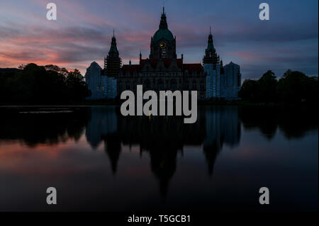 Hannover, Germany. 24th Apr, 2019. The town hall is reflected in the Maschteich at sunset. In the city hall affair in Hanover, the public prosecutor's office has accused Lord Mayor Shostok of severe infidelity. Credit: Christophe Gateau/dpa/Alamy Live News Stock Photo