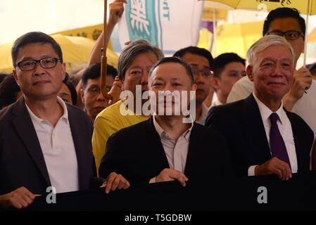 Hong Kong, China. 24th Apr, 2019. Sociology professor Chan Kin-man (left), law professor Benny Tai (center), and Baptist minister Chu Yiu-ming (right) chant slogans before entering the West Kowloon Magistrates Court in Hong Kong on Wednesday to receive their sentences after being convicted on 'public nuisance' charges for their role in organizing mass pro-democracy protests in 2014. Credit: Liau Chung-ren/ZUMA Wire/Alamy Live News Stock Photo