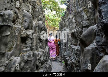 Visitors are seen walking around the asia's largest Rock Garden in Chandigarh. Rock Garden in Chandigarh is a sculptural art garden in India. The 40-acres Rock Garden is built of industrial waste and thrown-away items. Stock Photo