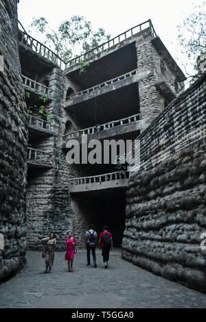 Visitors are seen walking around the asia's largest Rock Garden in Chandigarh. Rock Garden in Chandigarh is a sculptural art garden in India. The 40-acres Rock Garden is built of industrial waste and thrown-away items. Stock Photo