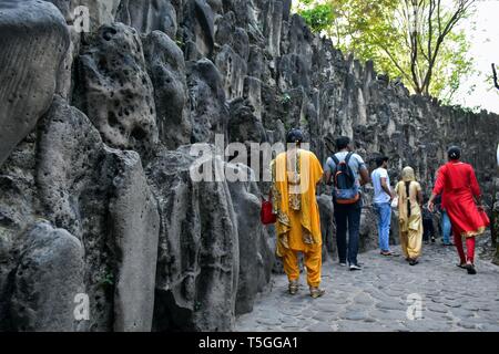 Visitors are seen walking around the asia's largest Rock Garden in Chandigarh. Rock Garden in Chandigarh is a sculptural art garden in India. The 40-acres Rock Garden is built of industrial waste and thrown-away items. Stock Photo