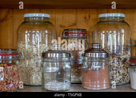 dry foods like cocoa, sugar and muesli stored environmentally friendly in glass jars Stock Photo
