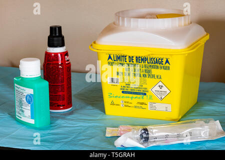 Yellow Medical waste container (with indication in French) use at home for cancer treatment Stock Photo