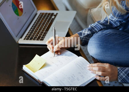 Woman taking notes, close-up Stock Photo