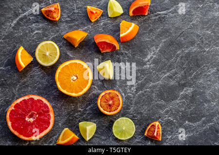 Sliced citrus fruits on slate Stock Photo