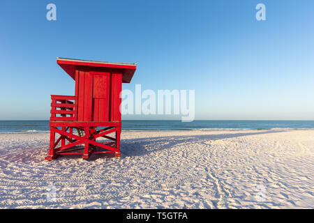 Red lifeguard tower on an early morning beach.  Copy space in the sky if needed. Stock Photo