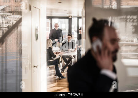 Business people work relaxed together in bright office Stock Photo