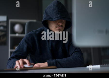Anonymous teenager hacking PC Stock Photo