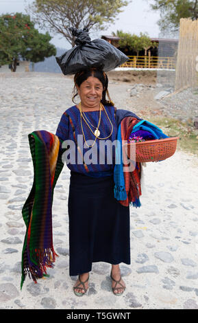 A middle aged guatemalan woman sellling scarves on the street, Santiago Atitlan town, Guatemala Central America