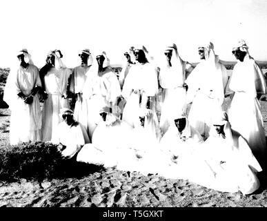 NASA astronauts posing for a group picture at Stead Air Force Base in Nevada after desert survival training, William Anders, Walter Cunningham, Roger Chaffee, Richard Gordon, Michael Collins, Clifton Williams, Eugene Cernan, David Scott, Donn Eisele, Russell Schweickart, Edwin Aldrin, Alan Bean, Charles Bassett and Theodore Freeman, August, 1964. Image courtesy National Aeronautics and Space Administration (NASA). () Stock Photo