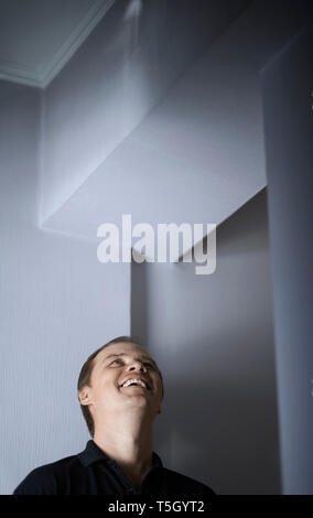Laughing man looking up Stock Photo