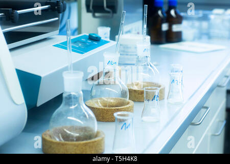 Laboratory glassware on table in lab Stock Photo