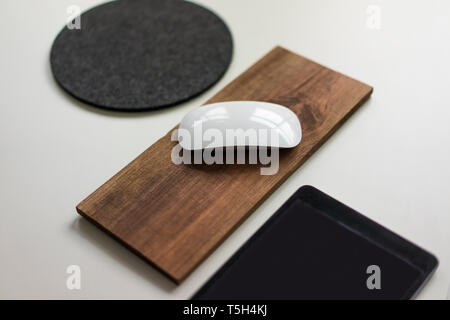 Computer mouse on wooden board on a desk Stock Photo