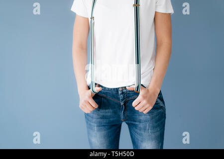 Woman stretching suspenders with her thumbs Stock Photo