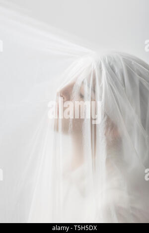 Graceful woman trapped in a veil Stock Photo
