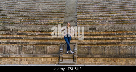 Happy young woman standing on stairs outdoors Stock Photo