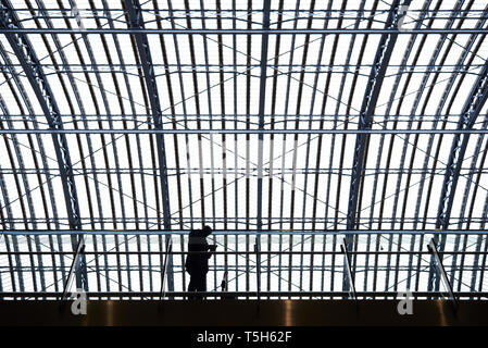 Silhouette of businessman standing on platform in train staion using mobile phone Stock Photo