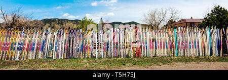 Wide panorama view of fence fabricated from old alpine skis; Salida; Colorado; USA Stock Photo