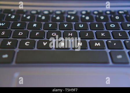 Part view of keyboard showing letters on laptop Stock Photo