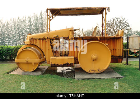 old roller compactor machine with yellow color on green garden High resolution image gallery. Stock Photo