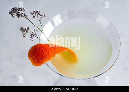 Corpse Reviver No. 2 classic Cocktail with orange peel and flower. Stock Photo