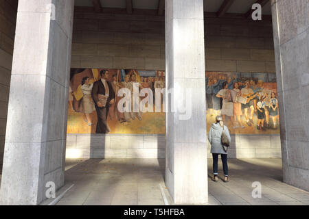 Berlin, Germany - tourists visit the Socialist Realism mural painted in 1952 in then East Berlin DDR by artist Max Lingner Stock Photo